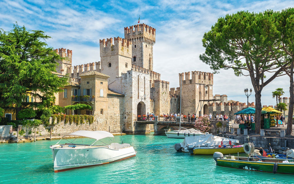 Castle with turquoise water and a boat